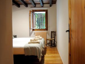 a bedroom with a bed with towels on it at CASERÍO MENDOZA by Urdaibai Experience in Gautegiz Arteaga