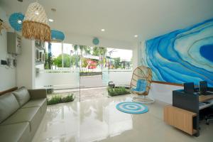 a living room with a couch and a chair at RedDoorz Plus @ Terban Residence in Yogyakarta