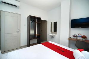 a white bedroom with a bed and a sink at RedDoorz Plus @ Terban Residence in Yogyakarta +29 photos