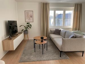 a living room with a couch and a table at Apartmán Sihoť - pri Zimnom Štadióne in Trenčín