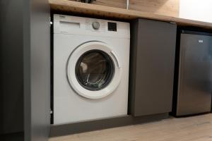a white washer and dryer in a kitchen at ADLER Studio in Łódź