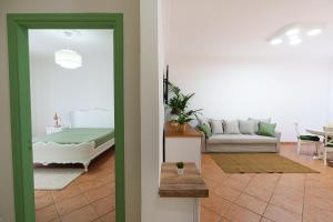 a living room with a couch and a table at House Marisa 5 minutes from the airport in Casoria