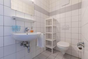 a white bathroom with a sink and a toilet at Pracondu 2 304 - OUTDOOR & FUN apartment 6 pers in Nendaz +15 photos