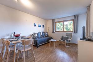 a living room with a couch and a table at Pracondu 2 304 - OUTDOOR & FUN apartment 6 pers in Nendaz