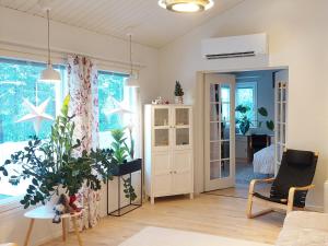 a living room with a table and a plant at House between pines 5-bedroom house with 3 toilets in Rovaniemi +31 photos