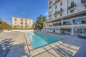 a swimming pool in front of a building at Aix-Riviera - 30min d'Annecy in Aix-les-Bains