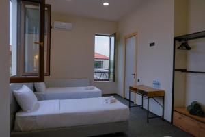 a hotel room with two beds and a window at Pura Vida Boutique Hotel Tbilisi in Tbilisi City