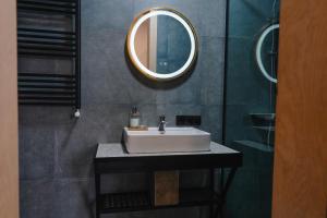 a bathroom with a white sink and a mirror at Camp Hotel Pura Vida in Tbilisi City