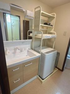 a bathroom with a sink and a mirror at 202 Room, a 6-minute walk from Tokyo Koiwa Station Direct connected to Shinjuku and Akihabara Stations Comfortable one-bedroom apartment with separate wet and dry areas in Tokyo