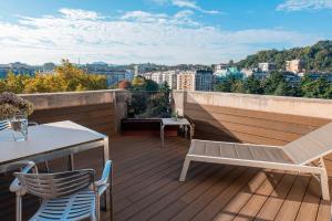 a balcony with a table and chairs on a roof at Eurostars Amara in Donostia-San Sebastián