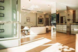 a living room with a large glass door and a table at Bazaar Inn Hotel in Tirana +68 photos