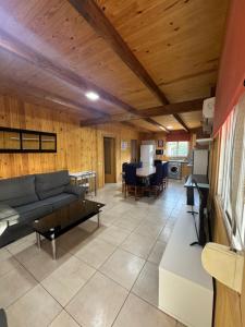 a living room with a couch and a table at Caseta De L'avi in Camarles