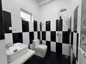 a black and white bathroom with a toilet and a sink at Santino Boutique in Mirissa +69 photos