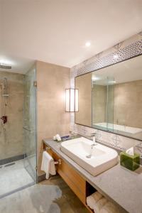 a bathroom with a sink and a shower at Park Inn by Radisson Lucknow Vikas Nagar in Lucknow