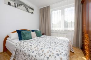 a bedroom with a bed and a window at Spacious Apartment Close to Warsaw for 5 people by Noclegi Renters in Konstancin-Jeziorna +14 photos