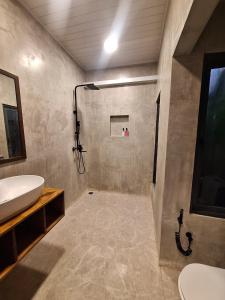 a bathroom with a sink and a toilet and a shower at New Breeze Thoddoo Inn in Thoddoo +134 photos