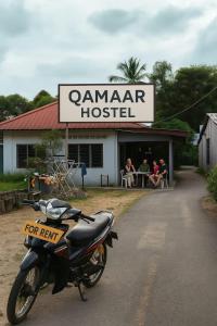 a motorcycle parked in front of a restaurant at Hostel Qamaar in Langkawi Intl