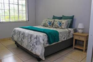 a bed with a green blanket on it in a bedroom at Newcastle Country Retreat in Newcastle +25 photos