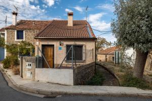 a small house on the side of a street at Casa De Los Abuelos in Ortigosa del Monte