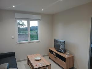 a living room with a table and a window at La pause enchantee in Villarcoin