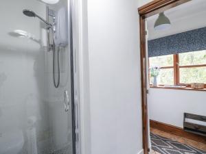 a bathroom with a shower with a glass door at Yoxall Cottage in Alton +32 photos
