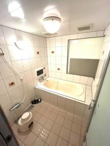 a bathroom with a tub and a toilet and a sink at Hotel An no Ie - Vacation STAY 80310v in Ikaho