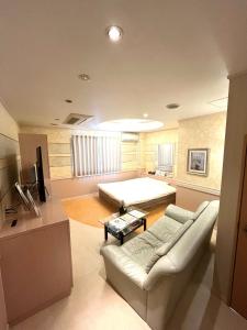 a living room with a couch and a bed at Hotel An no Ie - Vacation STAY 30029v in Ikaho +7 photos
