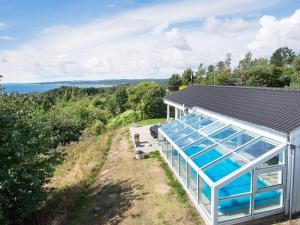 a greenhouse on the side of a house at Panoramic Pool Retreat - By Traum Ferienwohnungen in Ebeltoft