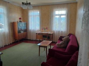 a living room with a red couch and a table at Armazi in Khulo
