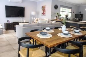 a living room with a wooden table and chairs at Newcastle Country Retreat in Newcastle