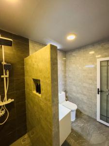 a bathroom with a white toilet and a shower at Ari Stay Thoddoo in Thoddoo +45 photos