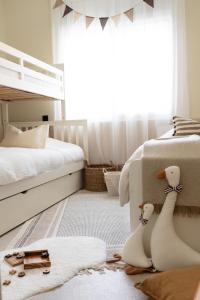 a bedroom with two beds and two stuffed animals on the floor at Bayt Tasnim - Résidence familiale sécurisée avec jardin privé in Tangier