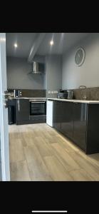 a kitchen with stainless steel appliances and a wooden floor at Atlantic beach house in Dog Island