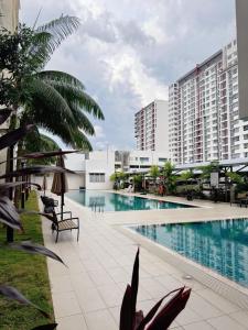 a large swimming pool in a building with buildings at Kalista1 in Seremban