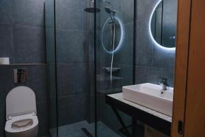 a bathroom with a sink and a toilet and a shower at Pura Vida Boutique Hotel Tbilisi in Tbilisi City