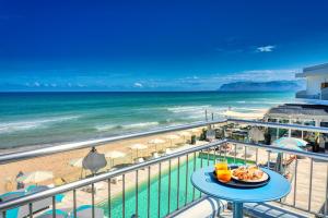 a view of the beach from the balcony of a resort at Hotel La Battigia in Alcamo Marina