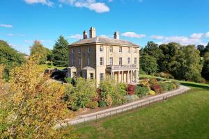 an old house with a garden in front of it at Hopton Court Apartment in Hopton Wafers