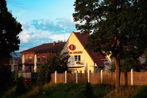 a yellow house with a fence in front of it at Hostel Ingeri in Viljandi
