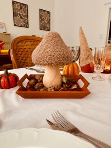 a mushroom in a tray on a table with a fork at Grande maison de ville MALO LEONE 250m2 pour 15 personnes proche du Puy du Fou in Mauléon