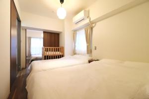 Postel nebo postele na pokoji v ubytování Cafune NAGOYA - Perfect for sightseeing in Nagoya and long-term stays! 3LDK with parking lot