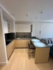 a kitchen with a table and a couch at Zep Promenade Spa Apartment in Vrnjačka Banja