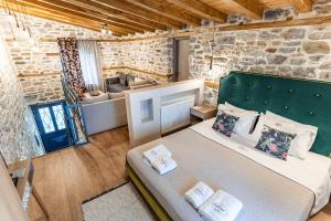 a bedroom with a bed and a couch in a room at Guesthouse Iris in Tsagarada