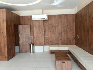 a waiting room with wooden walls and a bench at Triviera Hotel Chirala in Chīrāla