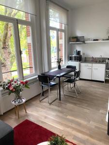 a kitchen with a table and chairs in a room at De Kardinaal in Den Bosch