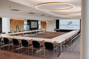 une salle de conférence avec une longue table et des chaises dans l'établissement Parkhotel Pforzheim, à Pforzheim