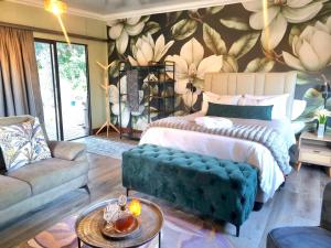 a bedroom with a bed and a flower wall at Fairfield Cottages in Ceres +62 photos
