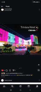 a website with pink lights on a city street at Triviera Hotel Chirala in Chīrāla
