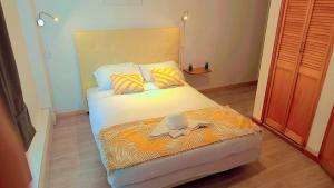 a bedroom with a bed with a hat on it at Le Faidherbe Hotel Coeur de ville in Boulogne-sur-Mer +30 photos