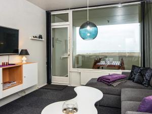 a living room with a couch and a tv at 4 person holiday home in Fanø in Fanø