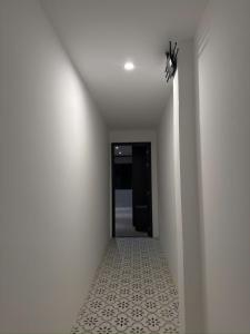 a hallway with a white wall and a ceiling at HY Local Budget Hotel - 5 mins walk to Hoi An Ancient Town in Hoi An